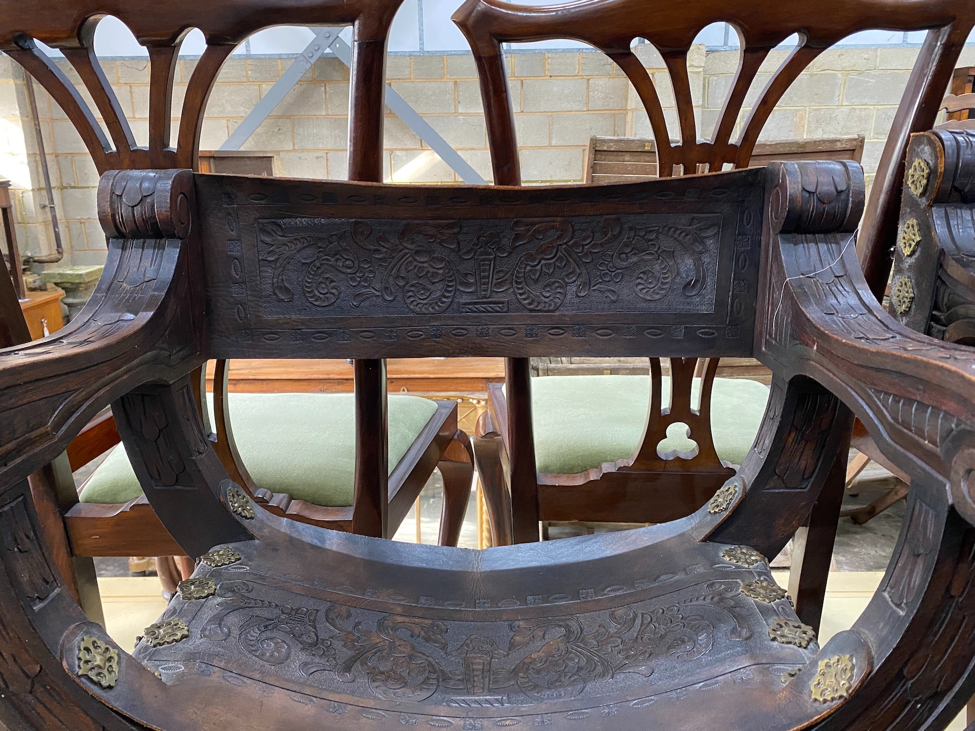 A pair of 19th century Spanish embossed leather and carved walnut framed 'X' framed armchairs, width 68cm, depth 42cm, height 76cm